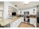 Kitchen with granite countertops, stainless steel appliances, and ample white cabinetry at 7401 35Th N Ave, St Petersburg, FL 33710