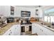 A close up view of the stainless steel stove, microwave, and the granite counters in the kitchen at 7401 35Th N Ave, St Petersburg, FL 33710