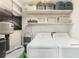 Bright laundry room with overhead storage and modern washer and dryer at 7401 35Th N Ave, St Petersburg, FL 33710