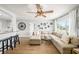 Bright and airy living room featuring a large sectional sofa, stylish decor, and an open layout connecting to the kitchen area at 7401 35Th N Ave, St Petersburg, FL 33710