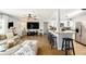 Spacious living room featuring sleek wood floors, a modern ceiling fan, and seamlessly connects to the kitchen at 7401 35Th N Ave, St Petersburg, FL 33710