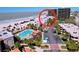 Aerial view of resort with parking, pool, and beach at 7564 Bayshore Dr # 302, Treasure Island, FL 33706