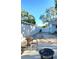 Wide open backyard with a white fence and outdoor seating next to a cozy fire pit at 801 53Rd N Ter, St Petersburg, FL 33703