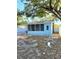 Exterior of home, showing screened in porch with privacy fence, surrounded by mature trees at 801 53Rd N Ter, St Petersburg, FL 33703