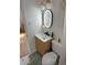 Bathroom with a toilet, a sink and a mirror with an oval led at 801 53Rd N Ter, St Petersburg, FL 33703