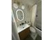 Bathroom with a toilet, a sink and a mirror with an oval led at 801 53Rd N Ter, St Petersburg, FL 33703