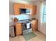 Kitchen with stainless steel oven and wooden cabinets at 801 53Rd N Ter, St Petersburg, FL 33703