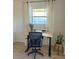 Bright and functional office space with an adjustable desk, ergonomic chair, and natural light at 801 53Rd N Ter, St Petersburg, FL 33703