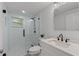Modern bathroom with a glass-enclosed shower and black fixtures at 8136 Honeybee Ln, Tampa, FL 33635