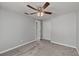 Neutral bedroom featuring ceiling fan, plush carpet, and closet, offering a calming and comfortable retreat at 8136 Honeybee Ln, Tampa, FL 33635