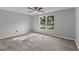 Bright bedroom featuring neutral paint, ceiling fan and carpet floors and natural light from large windows at 8136 Honeybee Ln, Tampa, FL 33635