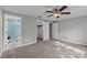 Bedroom with neutral paint, ceiling fan, and plush carpet leading to a full bathroom at 8136 Honeybee Ln, Tampa, FL 33635