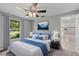 Beautifully staged bedroom featuring a comfortable bed, ceiling fan, and serene decor at 8136 Honeybee Ln, Tampa, FL 33635