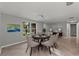 Elegant dining room with stylish decor, neutral colors, and a view of the backyard at 8136 Honeybee Ln, Tampa, FL 33635