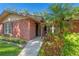 Close-up of the front entrance with brick facade and colorful flower accents at 8136 Honeybee Ln, Tampa, FL 33635