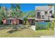 Charming brick home featuring a lush lawn, mature trees, and a covered carport, creating a welcoming curb appeal at 8136 Honeybee Ln, Tampa, FL 33635