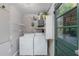 Functional laundry room with modern washer, dryer, and water heater at 8136 Honeybee Ln, Tampa, FL 33635