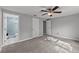 Neutral bedroom with carpet, fan, closet and en-suite bath with blue tiled shower at 8136 Honeybee Ln, Tampa, FL 33635