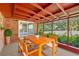 Covered patio with wooden table and chairs, perfect for outdoor dining and relaxation at 8136 Honeybee Ln, Tampa, FL 33635