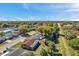 Aerial view showcasing the property's location within a quiet neighborhood, featuring mature trees and outdoor spaces at 10035 Cherry Creek Ln, Port Richey, FL 34668