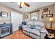 Cozy bedroom with decorative fireplace, comfortable seating and ceiling fan at 10035 Cherry Creek Ln, Port Richey, FL 34668