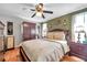 Comfortable bedroom with wood floors, neutral walls, a ceiling fan and dresser at 10035 Cherry Creek Ln, Port Richey, FL 34668