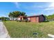 Charming single-story home featuring a well-maintained front yard and unique exterior accents for added curb appeal at 10035 Cherry Creek Ln, Port Richey, FL 34668