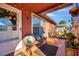 Inviting front porch with a bench seat, tiled floor and potted plants at 10035 Cherry Creek Ln, Port Richey, FL 34668