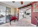 Inviting sunroom with tiled floor, sliding glass doors, and seamless flow into the bright and updated kitchen at 10035 Cherry Creek Ln, Port Richey, FL 34668