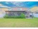 Large backyard features a screened lanai, a pergola, and lush greenery at 11118 Golden Silence Dr, Riverview, FL 33579