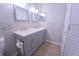 Bathroom with a double sink vanity with hexagon tile backsplash and a wood-look tile floor at 11118 Golden Silence Dr, Riverview, FL 33579