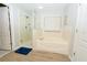 Bright bathroom featuring a separate glass-door shower and soaking tub at 11118 Golden Silence Dr, Riverview, FL 33579