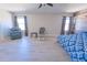 Bedroom boasts wood-look floors, natural light, and comfortable seating space at 11118 Golden Silence Dr, Riverview, FL 33579