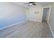 Bedroom features wood-look flooring, closet, and a ceiling fan at 11118 Golden Silence Dr, Riverview, FL 33579