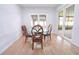 Bright dining area with glass table and sliding doors leading to the outdoor patio at 11118 Golden Silence Dr, Riverview, FL 33579