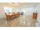 Dining room featuring wood flooring, a table and chairs under a hanging light fixture and bright, natural light at 11118 Golden Silence Dr, Riverview, FL 33579