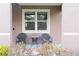 Cozy front porch features a table and chairs and a beautifully landscaped yard at 11118 Golden Silence Dr, Riverview, FL 33579