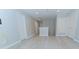 Open hallway with light grey walls, white trim, and light wood-style laminate flooring at 11118 Golden Silence Dr, Riverview, FL 33579