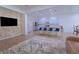 Bright kitchen with white cabinets, stone accent wall, a large island with blue bar stools at 11118 Golden Silence Dr, Riverview, FL 33579