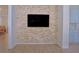 Stylish living room featuring a stone accent wall with a mounted TV at 11118 Golden Silence Dr, Riverview, FL 33579