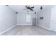 Open living room with light grey walls, white trim, and light wood-style laminate flooring at 11118 Golden Silence Dr, Riverview, FL 33579