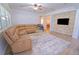 Comfortable living room features a large sectional sofa, decorative stone wall and ceiling fan at 11118 Golden Silence Dr, Riverview, FL 33579