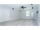 Open living room with light grey walls, white trim, and light wood-style laminate flooring at 11118 Golden Silence Dr, Riverview, FL 33579