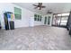 Large screened patio features tile flooring, ceiling fans, and ample space for relaxing and entertaining at 11118 Golden Silence Dr, Riverview, FL 33579