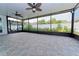 Large screened patio features tile flooring, ceiling fans, and an outdoor view perfect for entertaining at 11118 Golden Silence Dr, Riverview, FL 33579