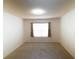 Neutral bedroom with carpeted floor, window with blinds and curtains, and a modern ceiling light at 11517 Koti Creek Ln, Thonotosassa, FL 33592