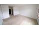 Bright bedroom with neutral carpet, freshly painted white walls and two doors at 11517 Koti Creek Ln, Thonotosassa, FL 33592