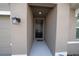 A welcoming, covered entrance with a stylish black front door and modern lighting at 11517 Koti Creek Ln, Thonotosassa, FL 33592