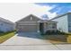Charming single-story home with a well-maintained lawn and a two-car garage at 11517 Koti Creek Ln, Thonotosassa, FL 33592