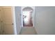Hallway with tile flooring leading to a dining area and hardwood floors at 11517 Koti Creek Ln, Thonotosassa, FL 33592